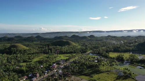 View From Above of Green Lands Cloudless Sky and Setting Sun Illuminating Forests and Hills with