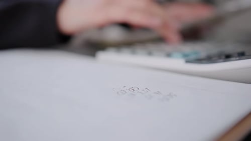 Woman Checking Bills Taxes Bank Account Balance and Calculating Expenses in the Living Room at Home