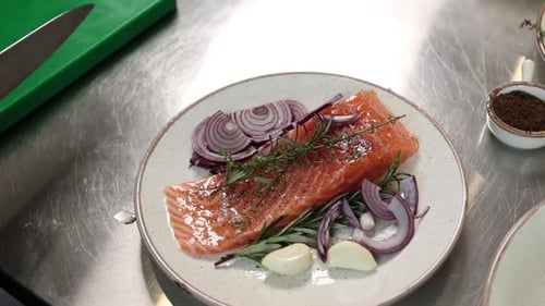 chef prepares a salmon dish in the kitchen. Close-up shots