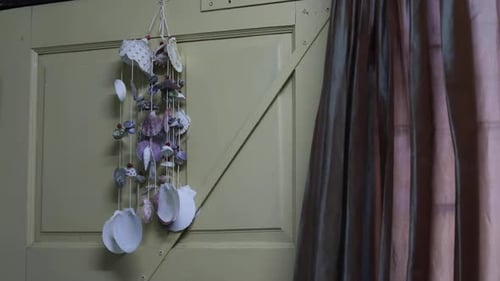 Sea Shells Hang On The Wooden Door For Decoration And Gently Moving On The Wind From Fan.- medium sh