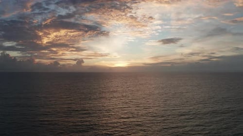 Aerial of the ocean at sunset