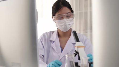 Female Scientist Using Microscope in Lab, Close Up