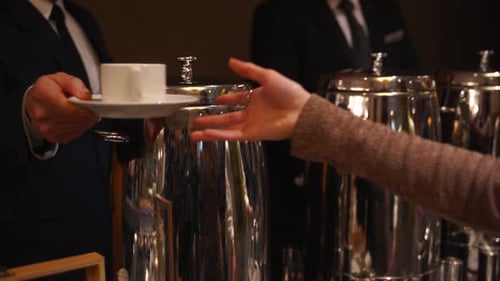 Woman asking the hotel clerk for tea. Open buffet with shiny look. Buffet restaurant, the hotel rest