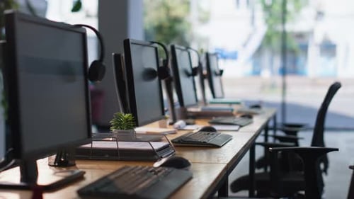 Empty Office Desks Computers and Headphones at Workspace Organized Call Center