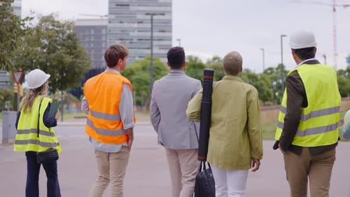 Team of Architects and Engineers Walking on Construction Site