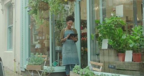 Young Adult with Tablet at Flower Shop