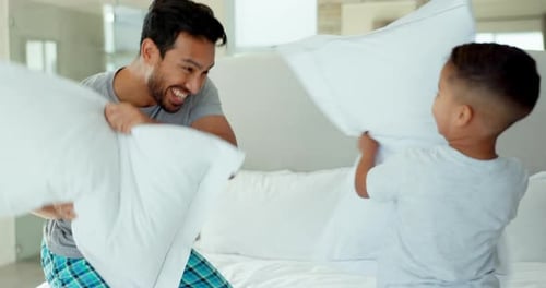 Dad and Son Pillow Fight on Bed