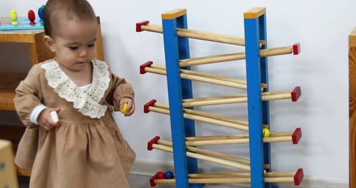 Baby Plays With Colorful Ball Run Toy