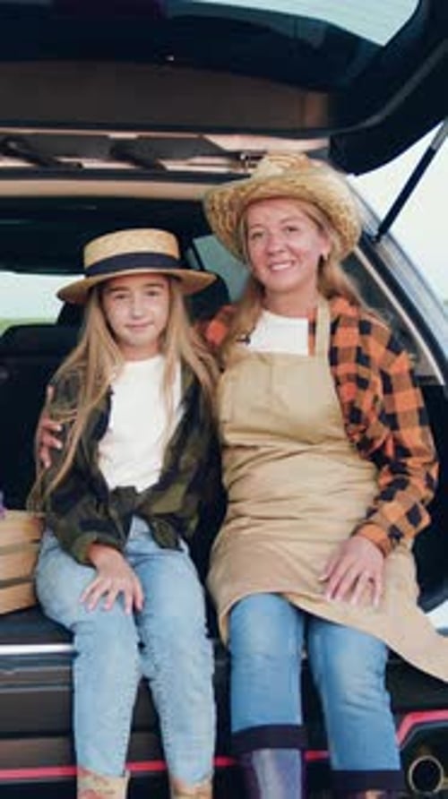 Mother and Daughter in Straw Hats Sitting in Car