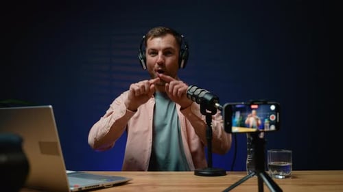 Man Filming Podcast Speaking Into Microphone