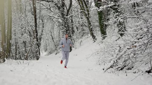 Sprinter Advances Rapidly In Snowy Forest Terrain Fast Athlete Pushes Forward On Cold Snowcovered