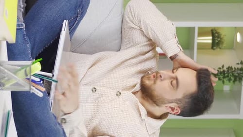 Stressed Man Working from Home on Laptop