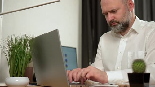 Sad Tired Worker Overworked on Computer Typing on Laptop Keyboard Finished Project Unhappy