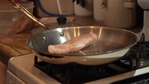 Chicken Frying in a Pan on the Stove