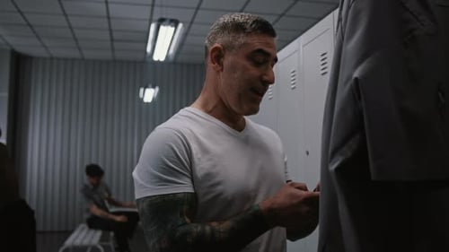 Athletic Airport Security Officer Interacting with Colleagues in Locker Room