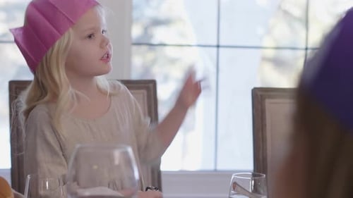 Family enjoys meal at indoor birthday celebration