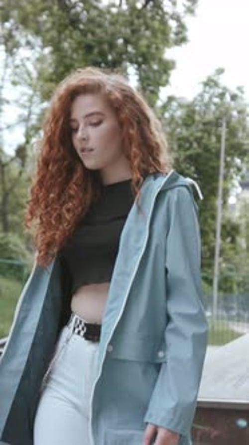 A Chic Young Woman is Enjoying Herself in an Outdoor Skate Park Dressed in a Stylish Outfit