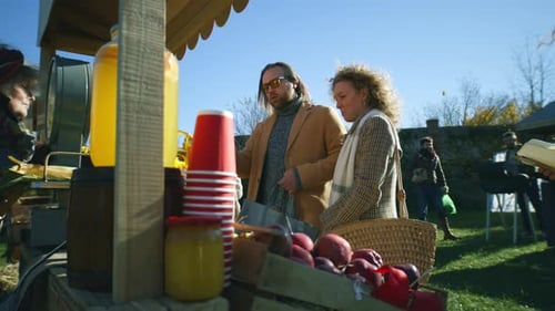 Couple Shopping at Outdoor Rural Farmers Market on Sunny Day