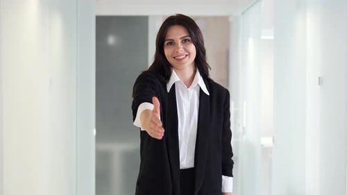 Businesswoman Extending Hand for a Handshake to Welcome Potential Collaborator