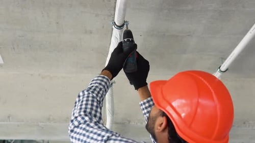 Indian Technician Installs Air Conditioning System at Office