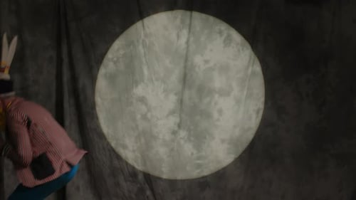 Clown Performing Comedy Routine with Props in Spotlight