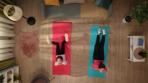 Woman and Child Stand on Fitness Mats and Perform an Exercise Warm Up The Mom Stretches with Her