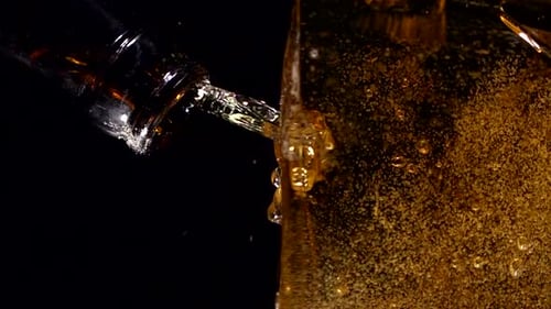 Beer Pouring into Container in Slow Motion