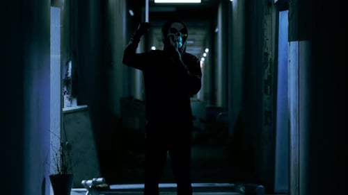 Scary Man In The Hooded Wearing Ghost Mask Silence While Holding A Knife In The Abandoned Hotel