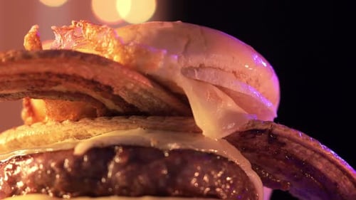 Delicious Cheeseburger Close Up With Bacon and Lights