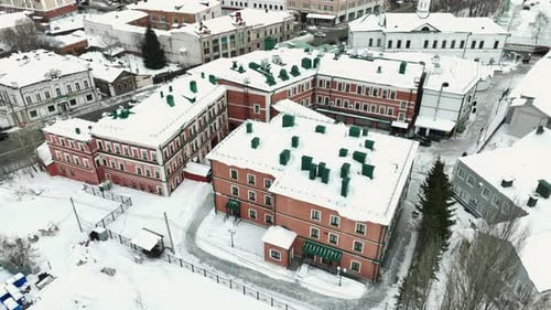Building with Rooftops Covered with Snow Against Traffic