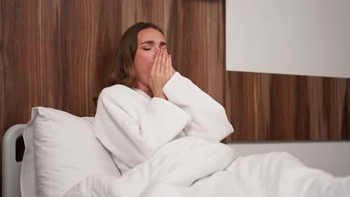 in Modern Clinic in a Bright VIP Room Lies Young Girl in a White Coat with a Cold Medical Care