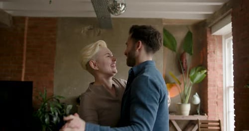Smiling Couple Dancing Together in a Home Interior