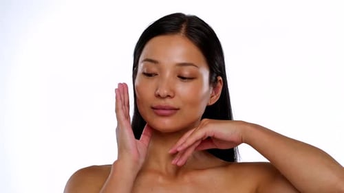 Woman Massaging Face and Neck in Close Up Shot