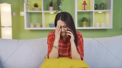 Sad Woman Crying After Phone Call on Couch