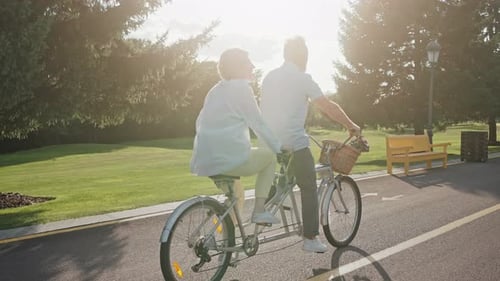Senior Couple Enjoying a Bicycle Ride in Park