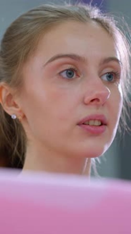 Focused Gym Instructor Guides Leg Exercise with Blue Converse