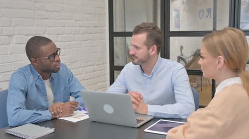 Mixed Race Entrepreneurs Discussing Business in Office
