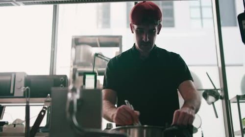 Chef Mixing Ingredients in Commercial Kitchen