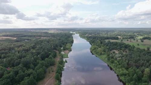 Aerial view of the river in the forest. Mist over the river and reflection of trees in water
