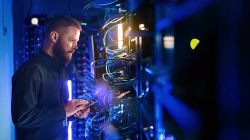 Man Working on Tablet in Server Room