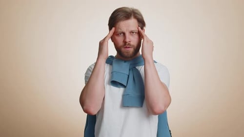 Adult Male with Headache Rubbing Temples