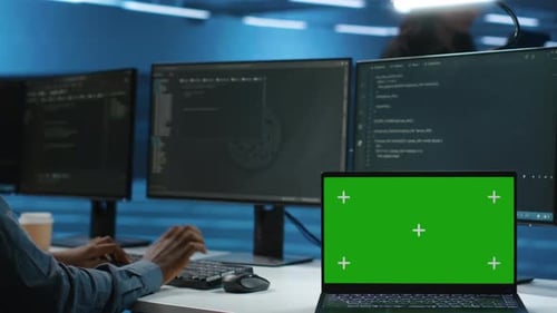 Expert Using Chroma Key Computer to Do Servicing on Data Center Rigs