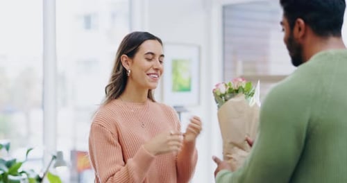 Woman Receives Flowers and Hug from Partner