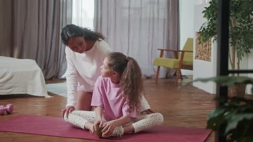 Mother and Little Cute Daughter Doing Stretching Exercises Training Together Cozy Home