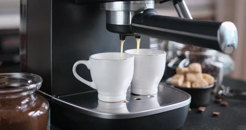 Home Espresso Making Process Coffee Stream Pouring From Machine Into Ceramic Cup