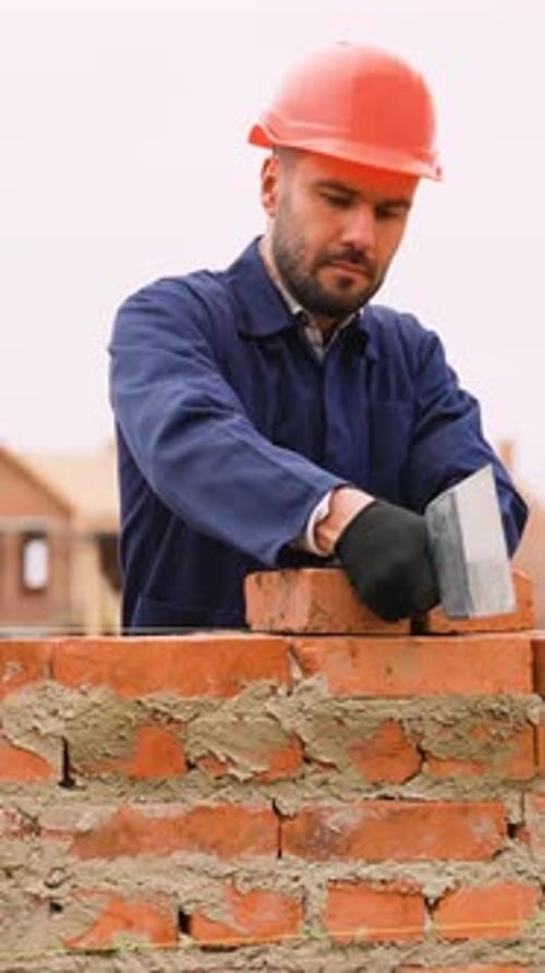 Bricklayer Working on Wall at Townhouse Construction Site