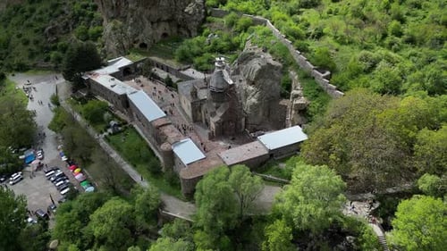 4K drone video of Geghard Monastery in Armenia. Zoom out shot from above. The church is located in a