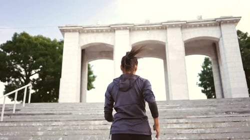 Woman Runs Up Concrete Steps for Exercise