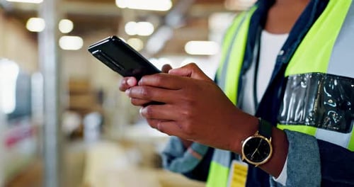 Construction, warehouse and closeup of architect with smartphone for research