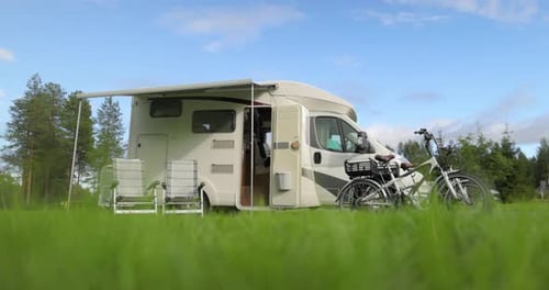 Camper Van and Bicycles in a Grassy Field